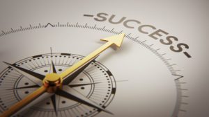a compass with an arrow pointing to success